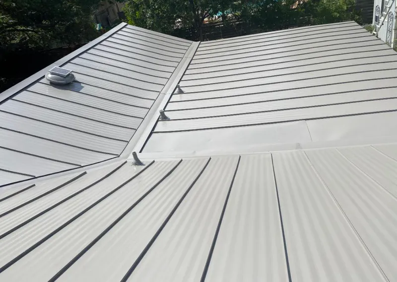 Solar attic fan installed on a metal roof for Roof Ventilation in Pontiac